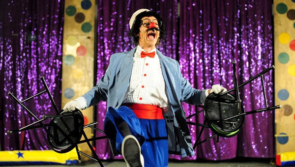 A clown laughs after removing four stools from beneath audience members during a trick during the José Cole Circus show at Glenville-Emmons High School when it visited the school in 2012. --Brandi Hagen/Albert Lea Tribune