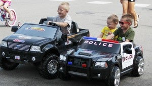 From left are Jace Ihrke, 6, Corbin Martens, 3, and Carter Martens, 5, who were leading the kiddie parade at New Richland’s Farm and City Days festival in 2012. All children are allowed in the parade as long as they’re on something that has wheels. Bicycles and scooters were plentiful in the parade.