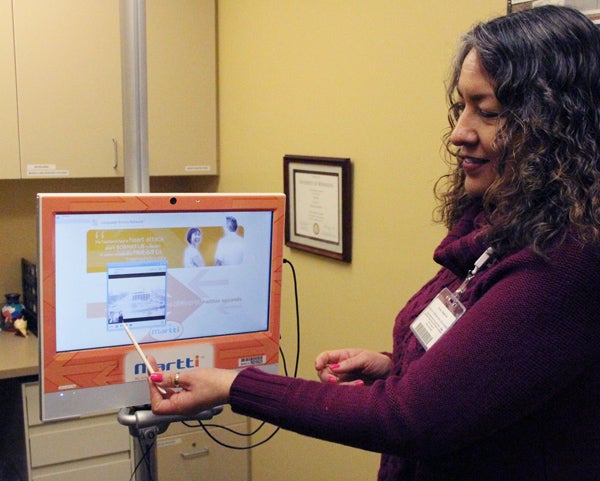 Glenna Kristy, manager of the language services department at Mayo Clinic Health System in Albert Lea, demonstrates how to use the Martti, a video interpreter device. --Kelli Lageson/Albert Lea Tribune