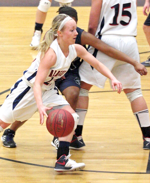 Bryn Woodside of Albert Lea uses a pick by Dominique Villarreal to cut to the basket at Rochester Century on Tuesday. Woodside led the Tigers with 18 points in a 49-39 comeback win. — Submitted