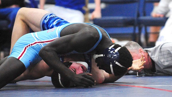 Bany Chan of Albert Lea attempts to pin his opponent from Owatonna this season. -- Micah Bader/Albert Lea Tribune