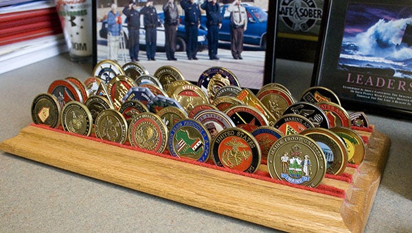 Albert Lea Police Department Lt. J.D. Carlson has collected these challenge coins over the years, mostly from his involvement in the military. -- Sarah Stultz/Albert Lea Tribune