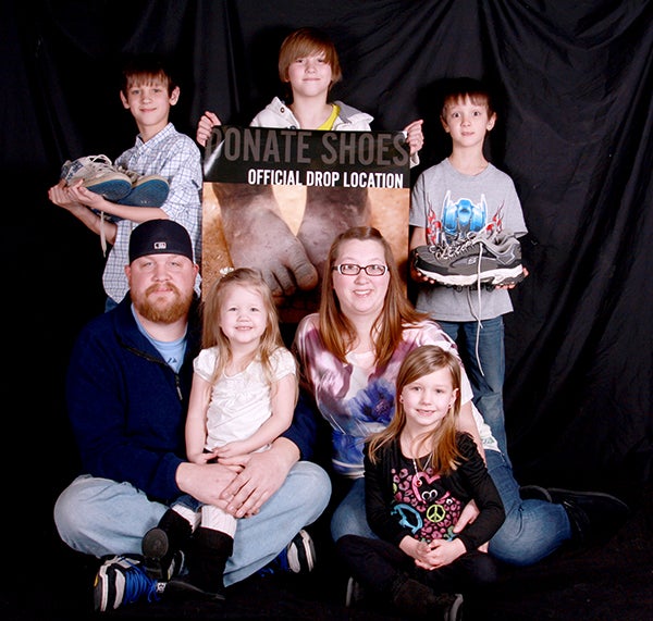 Randy Harig and his family are holding a shoe drive in to collect old shoes for Project Sole, a nonprofit charity. The shoes will go to needy people in countries overseas. Back row from left are Joshua Everett, 9, Garrett Everett, 11, and Lucas Everett, 8. Front row from left are Randy Harig, Addison Harig, 3, Nikki Everett and Paige Everett, 6. -- Brandi Hagen/Albert Lea Tribune