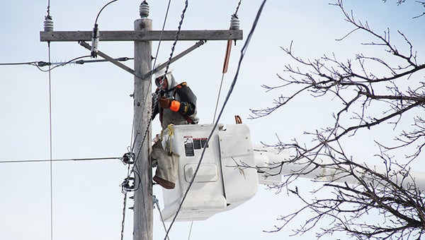 An Alliant Energy crewman installs upgrades to a utility pole Thursday on Richway Drive as part of the company’s Power Minnesota project. --Sarah Stultz/Albert Lea Tribune
