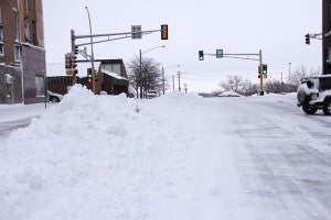 Snow gets piled in the middle of College Street this morning. Albert Lea residents have become accustomed to snow being piled in the middle of downtown streets after snowstorms. The snow gets hauled to a dump location later. -- Tim Engstrom/Albert Lea Tribune