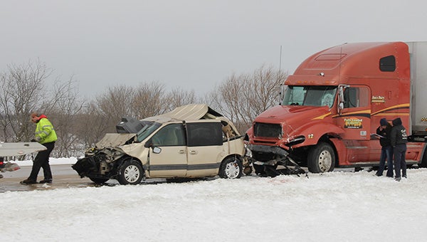 A van that was being pulled by a small pickup rests Monday by the side of southbound Interstate 35 in front of a semi that rear-ended it. — Tim Engstrom/Albert Lea Tribune
