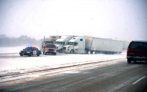 Two semis sit in the median of Interstate 35 near Exit 18 while another semi tries to pass Monday, March 18, 2013. Dozens of vehicles were in the ditch or median between Albert Lea and Clarks Grove after 5 p.m. -- Brandi Hagen/Albert Lea Tribune
