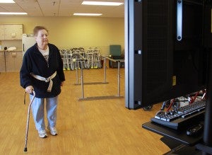 Ardella Skogheim uses the OmniVR, a virtual rehabilitation unit, to rehab her knee at St. John’s Lutheran Home. 
