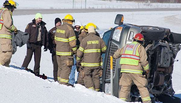 Freeborn County Sheriff's Office deputies and firefighters with the Albert Lea and Hayward fire departments respond Tuesday morning to a car that crashed into the median on Interstate 90 about a mile west of Hayward. -- Sarah Stultz/Albert Lea Tribune