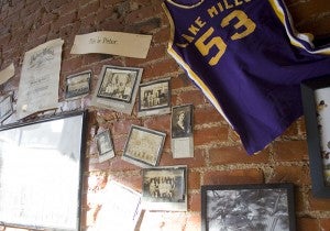 Old Lake Mills photos and jerseys hang on a wall at the Teluwut restaurant.