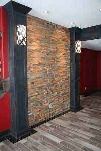Composite stone can be used as a backsplash or a vertical application for accent walls. RWP recently installed this stone in a new home. This accent wall has custom pillars to match the bar area. The flooring is wood-grain tile that is extremely durable. -- Submitted