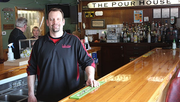 The Pour House owner Brian Lambert stands at the bar Wednesday morning as employees prepare to open for the day. --Tim Engstrom/Albert Lea Tribune