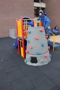 Two boys prepare to go down slides on the special-needs playground at Lakeview Elementary School.
