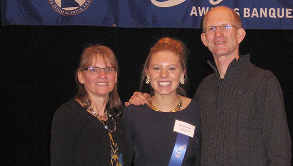Chrissy Monson, middle, a senior at Albert Lea High School, stands with her mother, Debbie, and father, Maurie, after receiving the Section 1AA Triple A Award at the Minnesota High School League Banquet. — Submitted