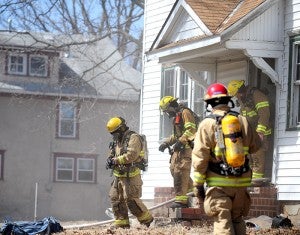 Firefighters exit a home at 816 W. William St. Thursday after extinguishing a fire they set in the back of the home as part of an investigation training. --Brandi Hagen/Albert Lea Tribune