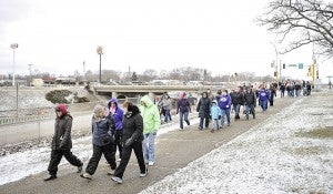 Participants in this year’s March for Babies walk along Interstate 90 after leaving the Holiday Inn and Convention Center in Austin on Saturday. This year marks the 75th anniversary of the March of Dimes. 