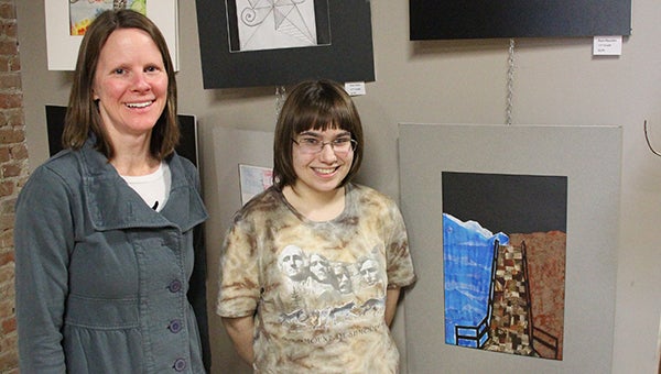 Teacher Raissa Byer and ninth-grader Amanda Bera stand next to Bera’s painting, which can be seen on display at Prairie Wind Coffee by other student art. Albert Lea High School art teachers have been working with the coffee shop to display student art throughout the year. --Kelli Lageson/Albert Lea Tribune