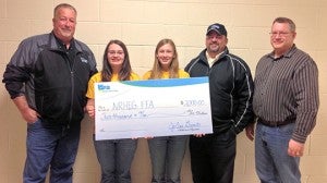 Watonwan Farm Services Operations Manager Craig Christenson, left, and WFS board member Neil Schlaak, second from right, present New Richland-Hartland-Ellendale-Geneva FFA chapter secretary Haylie Mosher, chapter Vice President Melissa Malakowsky and adviser Dan Sorum with a check for $2,000. --Submitted