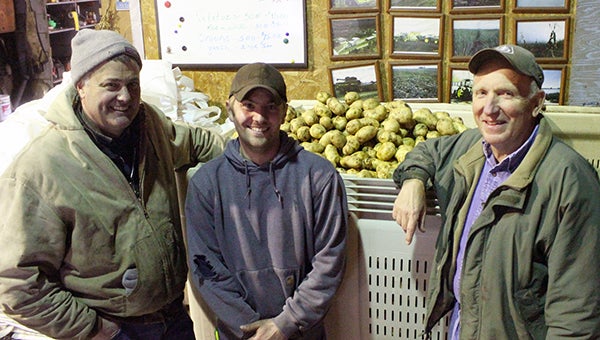 From left are Pete and Jon Van Erkel who operate Van Erkel Farms in Hollandale. On the right is Larry Reynen, who will be retiring this summer. Behind them is a big bin of Cascade potatoes, the variety used in Mrs. Gerry’s potato salad. --Kelli Lageson/Albert Lea Tribune