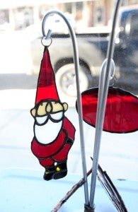 A Santa ornament made by Jimmy Clem hangs in the window of  Trish’s Gift Gallery in New Richland. 