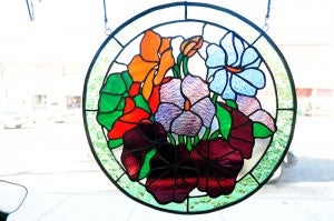 In order to make a piece of stained glass, it takes many different colors and textures of glass to get the right look as seen here in the different flowers.