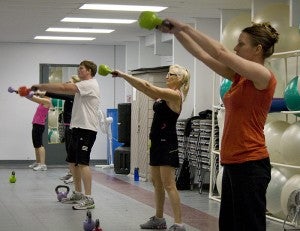 A kettlebell class at the YMCA keep their arms straight as they swing their kettlebells. The Y offers a 12:15 p.m. class on Tuesdays and Thursdays and a 6:45 p.m. class on Thursdays to accommodate working adults. 