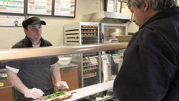 Subway manager Curtis Lind prepares an Italian BMT for customer Michael Nasinec. With just a 30-minute lunch break, Nasinec enjoys having the quick meal option. --Heather Rule/Albert Lea Tribune