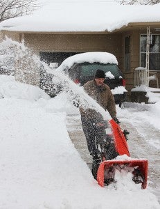 Doyle Lammie of Garden Road clears snow from his driveway Thursday morning with an Ariens snowblower, which he praised as more than capable of handling the heavy snow. -- Tim Engstrom/Albert Lea Tribune