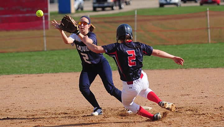 Albert Lea's Megan Kortan slides safely into second base during the bottom of the fifth inning, as Rochester Century's Morgan Hartman looks to make the catch. Albert Lea scored its only run in the bottom of the fifth inning in a 5-1 home loss. — Micah Bader/Albert Lea Tribune     