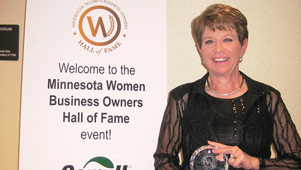 Geraldine Vogt, better known as Mrs. Gerry, holds her glass award on April 25 in Wayzata after being inducted into the Minnesota Women Business Owners Hall of Fame. --Submitted