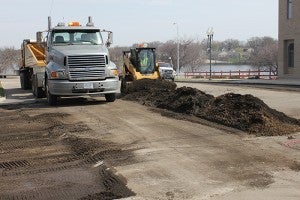 Another truck and trailer wait their turn to haul away milled asphalt Wednesday on Broadway in Albert Lea. Crews began tearing up the street as part of a plan to reconstruct Broadway. --Tim Engstrom/Albert Lea Tribune