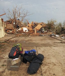 A rescued cat sits in a crate near the destroyed home of Amy Boyer and her boyfriend, John Salazar, in this photo taken by Albert Lea High School graduate Bob Boyer in Moore, Okla., on Tuesday. 