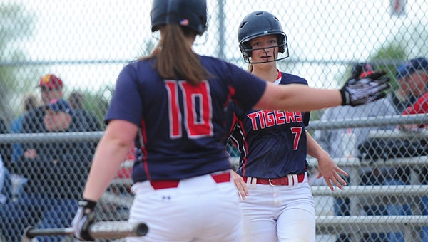Albert Lea's Alexa Wood celebrates Friday with Haley Schroader after scoring a run against Northfield in the first round of the consolation bracket of the Section 1AAA Tournament at Todd Park in Austin. Wood scored as a courtesy runner.