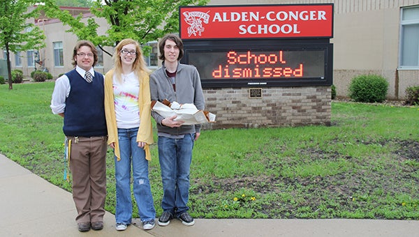 Students Taylor McCullough, 16, and Caitlin Galagan, 16, stand with Caitlin’s brother, Addison Galagan, 19, a recent graduate of Alden-Conger School. Addison drove around Alden picking up donations to an anti-bullying program as part of Community Service Day. --Tim Engstrom/Albert Lea Tribune