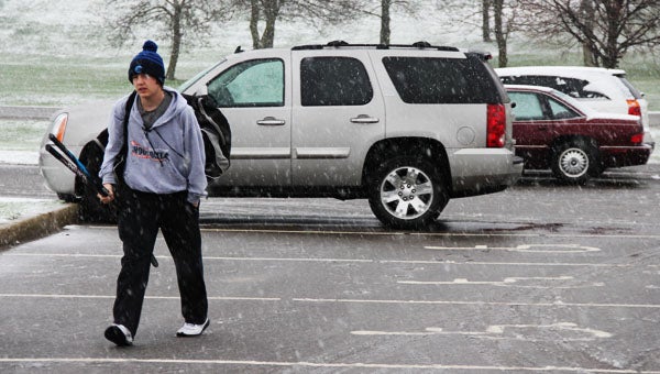 Eighth-grader Dawson Luttrell carries his hockey gear in heavy snow a little after 7 p.m. Wednesday to the City Arena, where he was meeting other players for a spring 4-on-4 league. It is rare to catch snow and daylight at that hour of the day. Sunset on the first day of May was at 8:16 p.m.