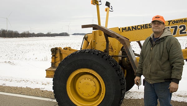 Manchester Township grader and snowplower Doug Jacobs stands in from of the motor grader the township is hoping to replace with funds from the energy production tax of the Bent Tree Wind Farm. --Sarah Stultz/Albert Lea Tribune