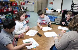Jenna Miller, a Title 1 teacher at Hawthorne Elementary School, works with a small group of fifth-grade students. The students from left are Oziel Valdez, Lilly Laite, Jacob Prihoda and Logan Schumaker. --Kelli Lageson