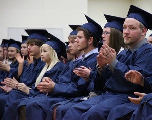 Albert Lea High School grads clap after a speech during commencement Friday evening. -- Kelli Lageson/Albert Lea Tribune 