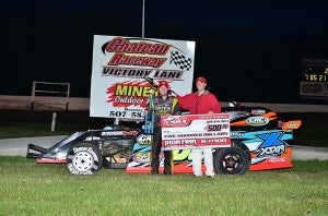 Cory Crapser holds his winings in victory lane after winning the USRA Iron Man B Mod feature on June 6 at Chateau Raceway in Lansing. — Buck Monson/Albert Lea Tribune  