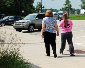 Jean Fedreico and Megan Darr walk back to their vehicle on Wednesday. The two were on their way to Mount Rushmore.