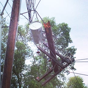 A power pole and its transformer dangle from their power lines on Sixth Avenue in Wells on Thursday morning, following an intensive thunderstorm Wednesday evening. --Lisa Foley/Albert Lea Tribune