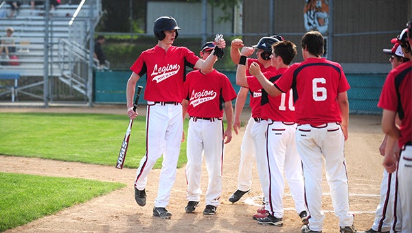 Dylan See-Rockers of the Albert Lea/Austin American Legion baseball team is congratulated by his teammates after scoring a run Monday against Winona at Hayek Field. — Micah Bader/Albert Lea Tribune