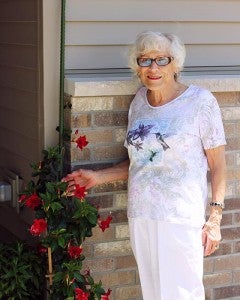Hazel Senske stands with some of her flowers. The weather has prevent Senske from getting her garden started this year. --Erin Murtaugh/Albert Lea Tribune