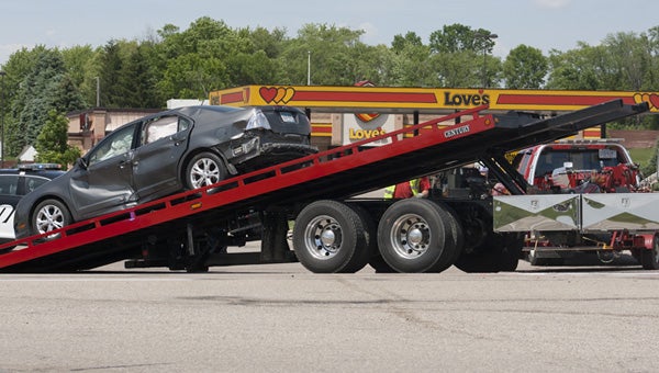 A car is loaded onto a flatbed trailer to be towed away from the scene of a car versus motorcycle crash on Freeborn County Road 46 Wednesday afternoon. -- Sarah Stultz/Albert Lea Tribune