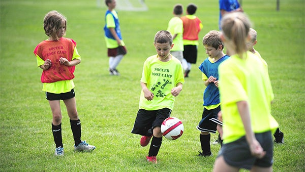 Malana Thompson, left, Drew Teeter, middle, and Jacob Ackerman, right, scrimmage Wednesday during a soccer camp at Lakeview Park organized by members of the Albert Lea boys’ and girls’ varsity soccer teams. — Micah Bader/Albert Lea Tribune