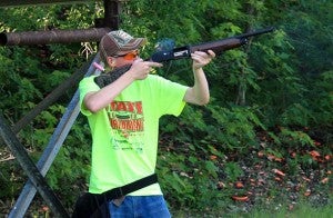 Tyler Koenen, a participant in the Minnesota Clay Target League, shoots at clay pigeons on June 13 at Oak Grove Gun Club. Club members were there to give pointers.