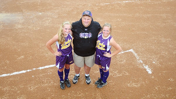 Rick Orban, middle, took over as the Lake Mills varsity softball head coach this year. His daughters Emily, left, and Sarah, right play on the team. Emily is the Bulldogs’ ace pitcher, and Sarah leads Lake Mills in hits, runs scored and stolen bases. — Micah Bader/Albert Lea Tribune