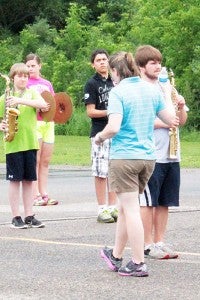 Suzanne Mauer lines up students on Wednesday. The group ran through a variety of exercises before practicing marching. 