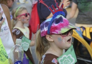 Magan Raatz, 8, sings a chant with the local Girl Scouts as part of the Third of July Parade. The parade theme in 2012 was “Celebrate Our Armed Forces.”