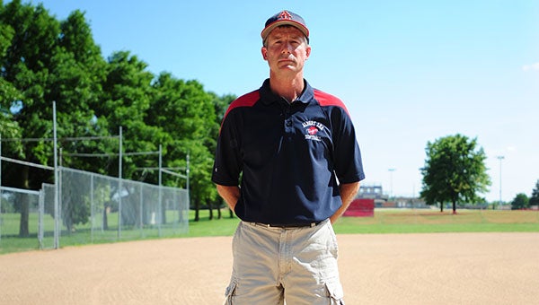 Dan Harms stands in front of the softball field at the Albert Lea Hammer Complex. Harms led the Tigers to a 7-12 record and two postseason wins. -- Micah Bader/Albert Lea Tribune